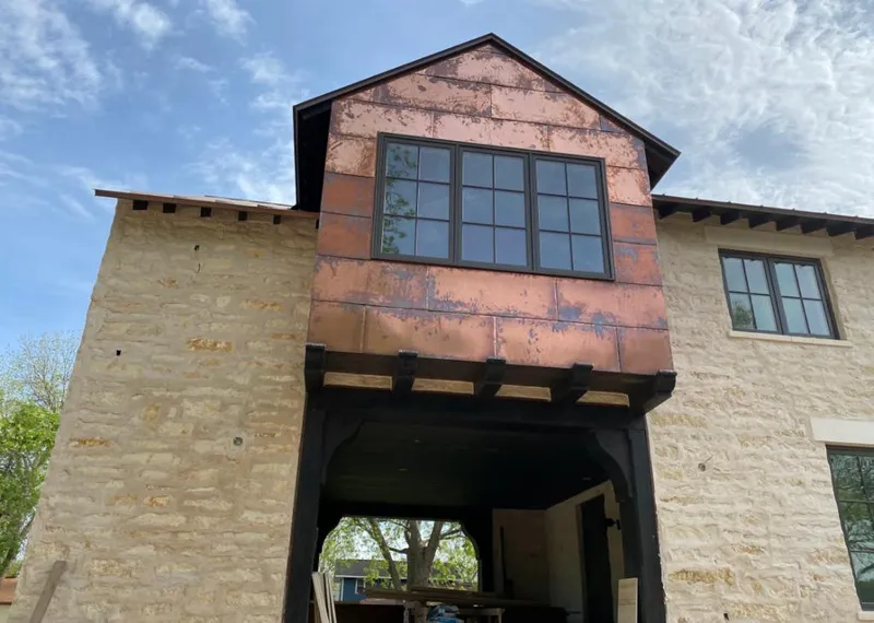 Copper metal panel facade on a stone building for Skylight Installation in Colonial Heights