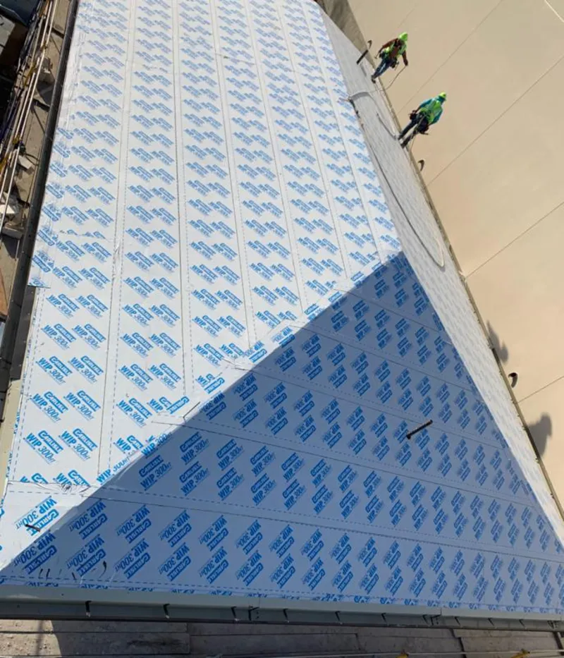 Professional roofers installing underlayment on a metal roof in Colonial Heights